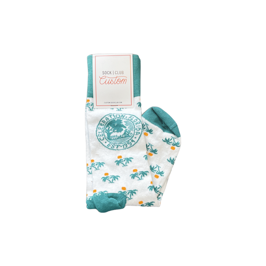 White socks with palm tree pattern and Celebration Florida logo